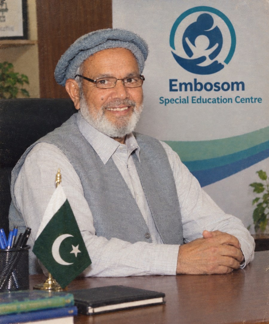 Syed Majeed Gilani, founder of Embosom Special Education Centre, at his desk